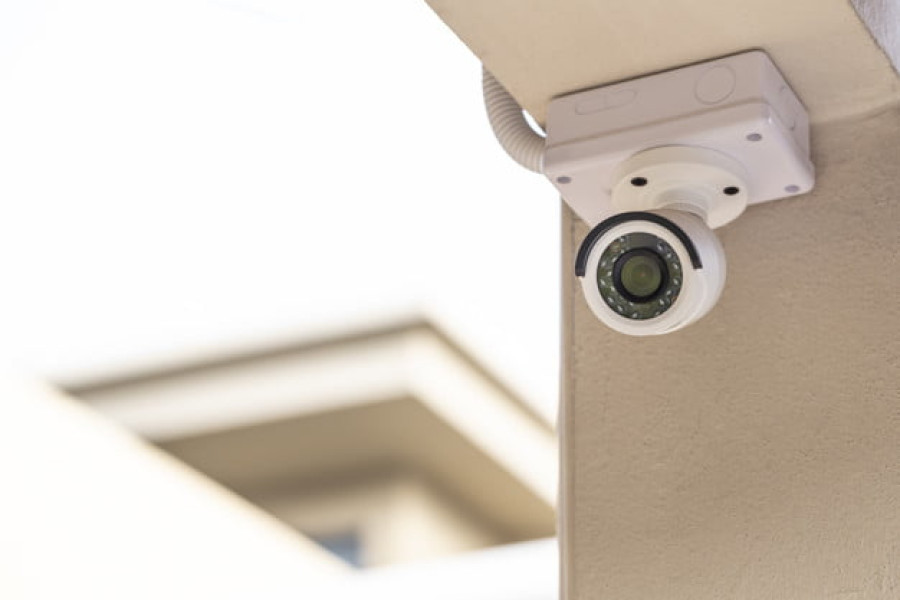 CCTV on the pillar of a house on white background